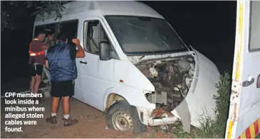  ??  ?? CPF members look inside a minibus where alleged stolen cables were found.