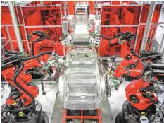  ??  ?? Robots assemble Model S sedans at Tesla’s 5.3-million-square-foot plant in Fremont, California. — Reuters