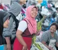  ??  ?? GETTING FRESH: A vendor sells vegetables at the market in downtown Narathiwat.