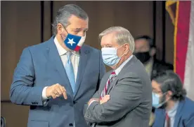  ?? POOL / GETTY IMAGES ?? U.S. Sen. Ted Cruz, R-Texas, left, speaks with Senate Judiciary Committee Chairman U.S. Sen. Lindsey Graham, R-S.C., during the Supreme Court confirmati­on hearing for nominee Judge Amy Coney Barrett last week.