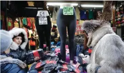  ??  ?? BROOKLYN: In this Dec 16, 2016 photo, women choose stockings for sale in a Brighton Beach clothing store.