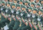  ?? AGENCIES ?? IRGC members (top) at a parade in Tehran; an anti-US banner (left) at a rally in Peshawar, Pakistan.