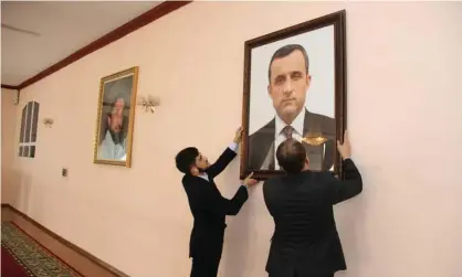  ??  ?? A portrait of Amrullah Saleh is put on the wall of the Afghan embassy in Dushanbe, Tajikistan. He has declared himself the ‘caretaker’ head of state. Photograph: Embassy Of The Islamic Republic/Reuters