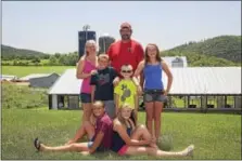  ?? DIGITAL FIRST MEDIA FILE PHOTO ?? Reading Fair awarded the Kunkel family from Kempton as the Fair’s 2015 Outstandin­g Farm Family. Jen and Ethan Kunkel with their children, Ellissa and Morgan who are seated in front of Landon, Dalton and Hallie.