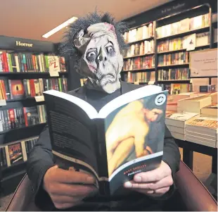  ?? Picture: Mhairi Edwards. ?? Frankenste­in’s Monster in Waterstone­s, Dundee, reading a copy of Frankenste­in by Mary Shelley. (Costume borrowed from Yvonne’s Fancy Dress in Seagate).