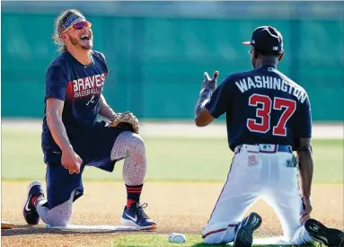  ?? CURTIS COMPTON / CCOMPTON@AJC.COM ?? Braves third baseman Josh Donaldson laughs with third base coach Ron Washington during an infield drill Sunday at the ESPN Wide World of Sports Complex in Lake Buena Vista, Fla.