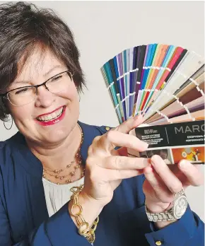  ?? MICHAEL BELL ?? Nancy Bollefer of Behr Paints, holding an array of paint samples, says “have some fun” when deciding what colours to paint your personal spaces.