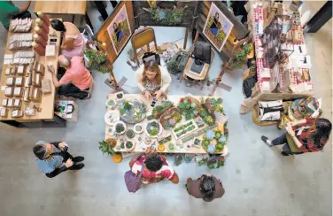  ?? Photos by Nathaniel Y. Downes / The Chronicle ?? Shoppers look at the wares offered for sale at the holiday gift fair sponsored by SFMade and Pinterest.