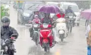  ?? SHANKAR MOURYA/HT ?? Commuters drive through pouring rain in Indore on Sunday. Seven people lost their lives due to heavy rains in different parts of Madhya Pradesh in the last 24 hours.