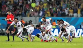  ?? Quinn Rooney/AFP/Getty Images ?? Costa Rica celebrates after defeating Greece in a penalty shootout during the Round of 16 match. They will face a very strong Netherland­s Saturday in the quarter-finals.