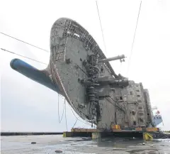  ?? AFP/SOUTH KOREAN MARITIME MINISTRY ?? The ‘Sewol’ ferry is placed onto a submersibl­e vessel off the coast of the southern South Korean island of Jindo yesterday.