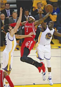  ?? Associated Press ?? Houston Rockets forward Josh Smith shoots between Golden State Warriors center Andrew Bogut, left, and forward Draymond Green during Game 5 of the NBA Western Conference finals Wednesday in Oakland, Calif.