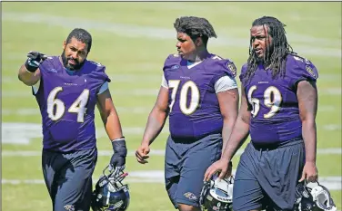  ?? (File Photo/AP/Patrick Semansky) ?? Baltimore Ravens guard John Urschel (left) speaks with teammates Robert Myers (70) and Leon Brown as they walk off the field after NFL football training camp in Owings Mills, Md., in August 2015.