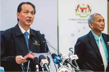  ?? PIC BY LUQMAN HAKIM ZUBIR ?? Health directorge­neral Datuk Dr Noor Hisham Abdullah (left) speaking at a daily Covid-19 media briefing at the Health Ministry in Putrajaya yesterday.