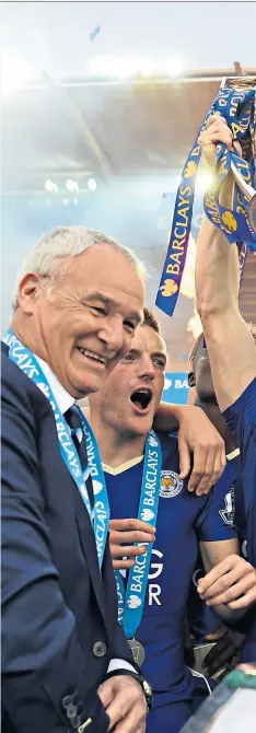  ??  ?? Moment of triumph: Claudio Ranieri and his team-mates look on as Andy King lifts the Premier League trophy in 2016