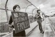  ?? Michael Minasi / Staff photograph­er ?? Montgomery County residents protest on the North Loop 336 overpass above Interstate 45 in Conroe.