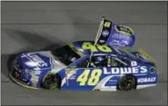  ?? DARRYL GRAHAM — THE ASSOCIATED PRESS ?? Jimmie Johnson hold his flag as he does the victory lap after wining the NASCAR Sprint Cup auto race and season title Sunday in Homestead, Fla.