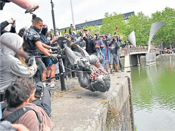  ?? Picture: PA. ?? Protesters throw statue of Edward Colston into Bristol harbour during a Black Lives Matter protest rally.