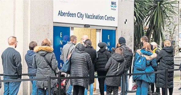  ?? ?? EAGER FOR JAGS: People queue outside the Aberdeen City Vacination Centre in the building of the old John Lewis store. Picture by Wullie Marr.