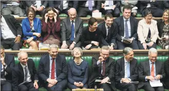  ?? Jessica Taylor / Associated Press ?? In this handout photo provided by the U.K. Parliament, Britain’s Prime Minister Theresa May, first row center, laughs during the Brexit debate in the House of Commons on Thursday.