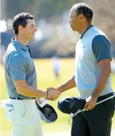  ??  ?? Put it there: McIlroy and Woods