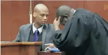  ?? MERVYN NAIDOO ?? AUSTIN Reynold in conversati­on with his attorney Sizwe Masondo at the Durban High Court. |