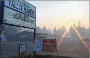  ?? ERIC WHITNEY / KAISER HEALTH NEWS / TNS ?? Wildfire smoke fills the sky in Seeley Lake, Mont., in August 2017. Weather effects concentrat­ed the accumulati­ng smoke, chronicall­y exposing residents to harmful substances.