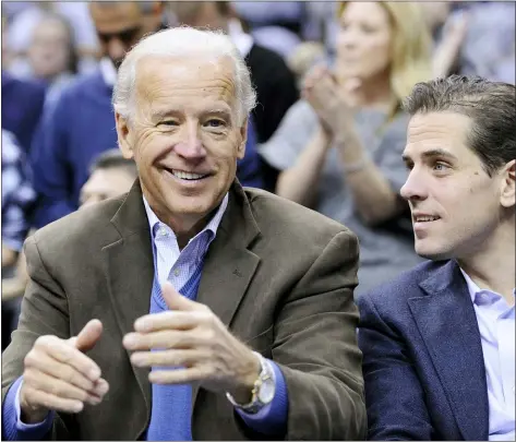  ?? NICK WASS — THE ASSOCIATED PRESS FILE ?? In this file photo, Vice President Joe Biden, left, with his son Hunter, right, at the Duke Georgetown NCAA college basketball game in Washington. Since the early days of the United States, leading politician­s have had to contend with awkward problems posed by their family members. Joe Biden is the latest prominent politician to navigate this tricky terrain.