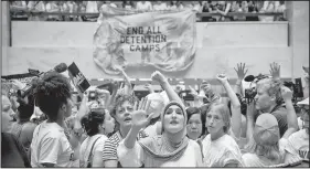  ?? AP/J. SCOTT APPLEWHITE ?? Hundreds of activists, including actress Susan Sarandon, center left, with protest organizer Linda Sarsour, challenge the Trump administra­tion’s approach to illegal border crossings and separation of children from immigrant parents, in a Thursday...