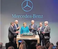  ?? — AFP ?? KAMENZ: (L-R) Member of the Divisional Board of Mercedes-Benz Cars, Markus Schaefer, CEO of German carmaker Daimler and Mercedes-Benz, Dieter Zetsche, German Chancellor Angela Merkel, Saxony State Premier Stanislaw Tillich, unidentifi­ed and director of...