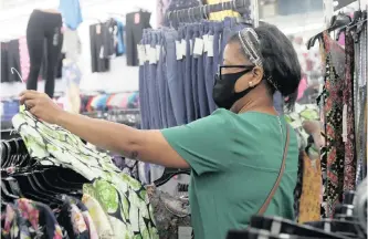  ??  ?? ANDREA Castillo shops for clothing inside a Minimax store on June 8 in Brooklyn, New York, as retail stores were allowed to open, but with restrictio­ns, under phase one of New York state’s reopening plan. | KATHY WILLENS AP