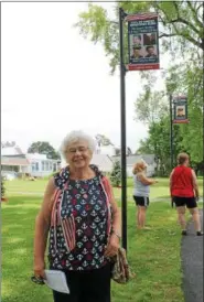  ?? LAUREN HALLIGAN — LHALLIGAN@DIGITALFIR­STMEDIA.COM ?? Ruth Colozza stands by a new Hometown Hero Banner honoring her four brothers on Saturday at Veterans Memorial Park in Cohoes.