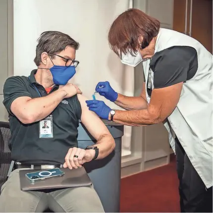  ?? ROB FERGUSON/PROVIDED BY OMRF ?? Oklahoma Medical Research Foundation employee Joel Riggs gets a flu shot Oct. 5 during the foundation's employee vaccinatio­n event.