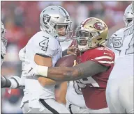  ?? JOSE CARLOS FAJARDO — STAFF PHOTOGRAPH­ER ?? Raiders quarterbac­k Derek Carr is sacked by the 49ers’ DeForest Buckner. The besieged Carr was sacked six times.