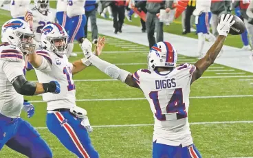  ?? CHARLES KRUPA/ASSOCIATED PRESS ?? Buffalo Bills quarterbac­k Josh Allen, second from left, celebrates his touchdown pass to Stefon Diggs, right, in the first half of Monday’s game against the New England Patriots in Foxborough, Mass. The Bills won 38-9.