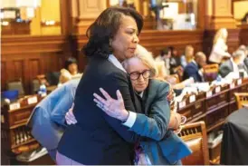  ?? ARVIN TEMKAR/ATLANTA JOURNAL-CONSTITUTI­ON VIA AP ?? State Rep. Debra Bazemore, D-South Fulton, left, embraces Rep. Karla Drenner, D-Avondale Estates, after Drenner spoke against SB 140 at the House of Representa­tives in Atlanta. Rep. Drenner was the first openly gay member of Georgia legislatur­e.