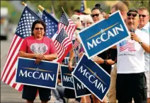  ??  ?? WELL WISHERS LINE THE STREET TO PAY their final respects as they wait for the hearse carrying McCain to pass as it heads to his memorial service, Thursday in Phoenix.