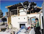  ?? David Goldman ?? The Associated Press Marla Wood pulls a framed picture out of the rubble of her damaged home Sunday in Mexico Beach, Fla.