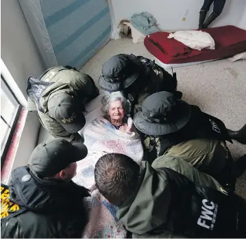  ?? GERALD HERBERT / THE ASSOCIATED PRESS ?? Emergency responders from Louisiana and Florida help transport an elderly woman from the Golden Years Assisted Living home, which was flooded Wednesday from Tropical Storm Harvey, in Orange, Tex.