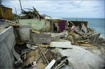  ?? CARLOS GIUSTI – THE ASSOCIATED PRESS ?? Debris lies on the ground Monday near several houses that were destroyed in the community of La Perla in Old San Juan during Hurricane Maria in San Juan, Puerto Rico. The island territory of more than 3 million U.S. citizens is reeling in the wake of...