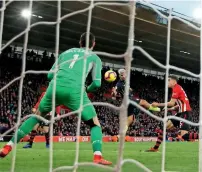  ?? Reuters ?? Manchester City’s Sergio Aguero scores the third goal for his team past Southampto­n’s Alex McCarthy. —