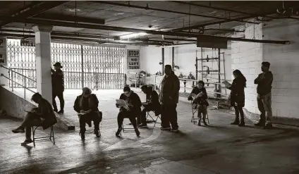  ?? Associated Press file photo ?? Hospitalit­y workers wait to apply for unemployme­nt benefits in Los Angeles in March. In sectors such as restaurant­s and hotels, employment remains far below pre-pandemic levels.