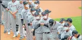  ?? AP ?? Hanwha Eagles players wearing face masks line up during the start n of their game against SK Wyverns in Incheon, South Korea.