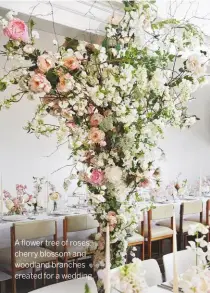  ??  ?? A flower tree of roses, cherry blossom and woodland branches created for a wedding.