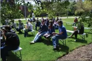  ?? SHEENA HOLLAND DOLAN — THE NEWS-HERALD ?? Attendees on May 1spread out on the library’s lawn to listen to the recitation­s of the winning poems from the tree-themed poetry competitio­n. Adults, teens and children alike submitted poems about their personal connection­s to trees.