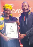  ?? ?? Molatela Hlaka receives her fiveyear service award from Sammy Mokhele (general manager).