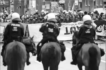  ??  ?? Mounted police observe activists protesting against Germany’s anti-immigratio­n party Alternativ­e for Germany (AfD) before the AfD’s party congress in Cologne, Germany. — Reuters photo