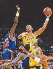  ?? Rick Stewart/Allsport/Getty Images ?? Kareem Abdul-Jabbar (33), center for the Los Angeles Lakers, jumps to make a layup over Patrick Ewing (33) of the New York Knicks on Jan. 22, 1988 at the Great Western Forum arena in Inglewood, Calif.
