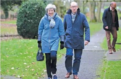 ?? Agence France-presse ?? Theresa May leaves with her husband Philip after attending a church service, near her Maidenhead constituen­cy, west of London, on Sunday.