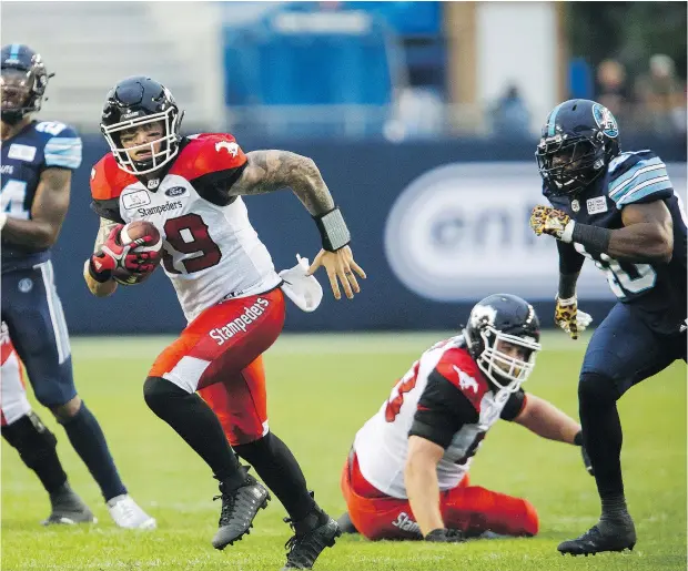  ?? — THE CANADIAN PRESS ?? Stampeders quarterbac­k Bo Levi Mitchell rushes upfield during the first half of Saturday’s game against the Argonauts at BMO Field in Toronto. Mitchell had a stellar night, completing 20 of 22 passes for 324 yards and three touchdowns.